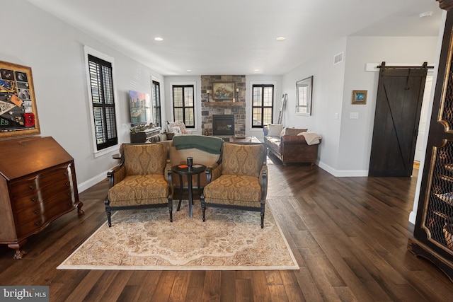 33 Docwill Dr, Barto, PA 19504 - living room with baseboards, a barn door, a stone fireplace, and visible vents