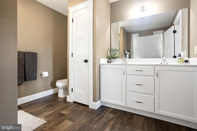 33 Docwill Dr, Barto, PA 19504 - bathroom with a sink, toilet, wood finished floors, double vanity, and baseboards