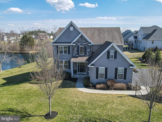 33 Docwill Dr, Barto, PA 19504 - traditional-style home featuring roof with shingles, a water view, a front lawn, and a residential view