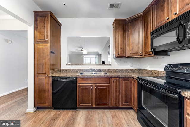 8609 Wintergreen Ct Unit 308, Odenton, MD 21113 - kitchen with black appliances, a sink, light wood-style flooring, dark countertops, and a ceiling fan