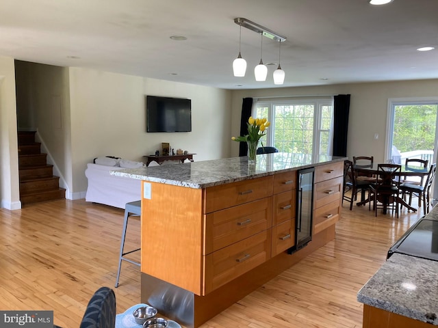 5 Garfield Ct, Gaithersburg, MD 20882 - kitchen with wine cooler, a kitchen bar, light wood finished floors, recessed lighting, and a kitchen island