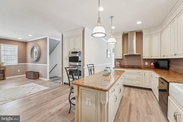 806 209th St, Pasadena, MD 21122 - kitchen featuring wall chimney exhaust hood, light wood finished floors, a kitchen island, light stone counters, and recessed lighting