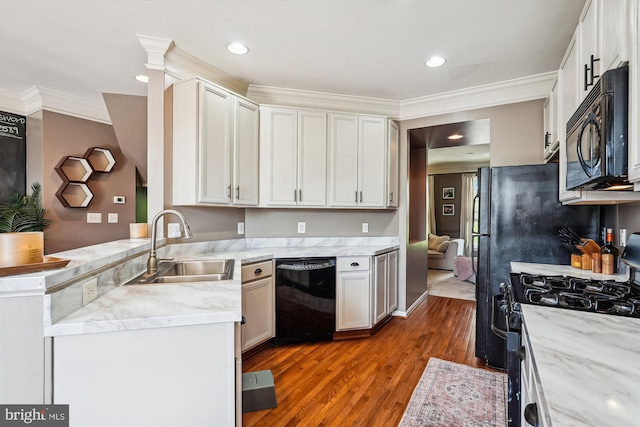 12205 Desoto Falls Ct, Bristow, VA 20136 - kitchen with black appliances, a sink, wood finished floors, a peninsula, and light stone counters