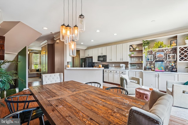 12205 Desoto Falls Ct, Bristow, VA 20136 - dining area with recessed lighting, light wood-style floors, and crown molding