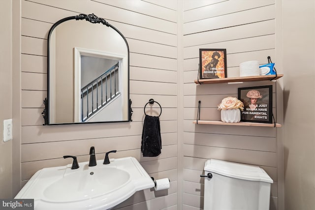 12205 Desoto Falls Ct, Bristow, VA 20136 - bathroom with a sink, toilet, and wooden walls