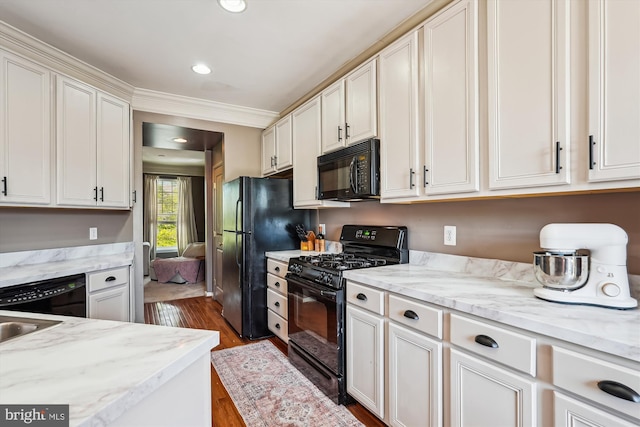 12205 Desoto Falls Ct, Bristow, VA 20136 - kitchen featuring black appliances, dark wood-type flooring, white cabinetry, crown molding, and light stone counters