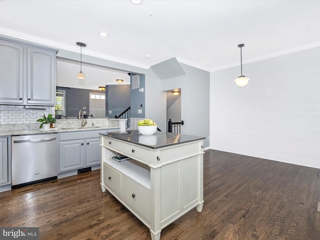 kitchen featuring stainless steel dishwasher, a sink, dark wood-style flooring, decorative backsplash, and ornamental molding