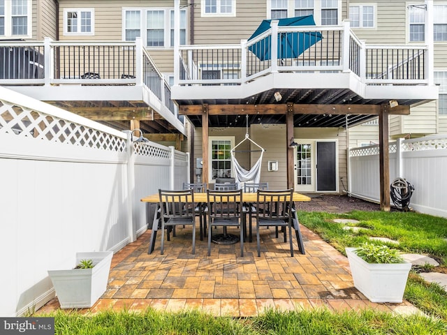 view of patio / terrace featuring outdoor dining space, a fenced backyard, and a deck