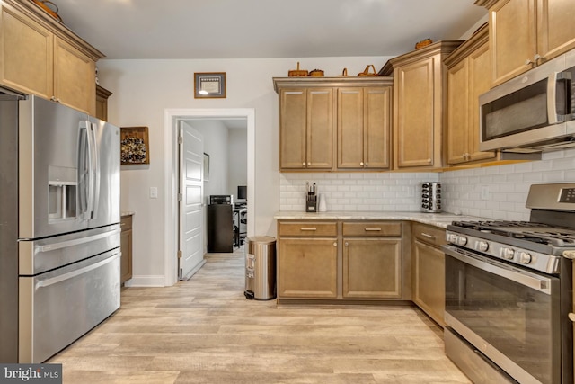 40 Doc Ct, Felton, DE 19943 - kitchen with stainless steel appliances, light wood-type flooring, tasteful backsplash, baseboards, and light stone counters