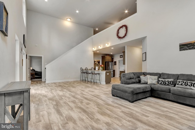 40 Doc Ct, Felton, DE 19943 - living room featuring a high ceiling, stairway, light wood-style flooring, baseboards, and recessed lighting