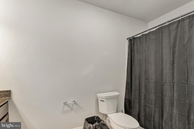 40 Doc Ct, Felton, DE 19943 - bathroom featuring vanity, toilet, baseboards, and curtained shower