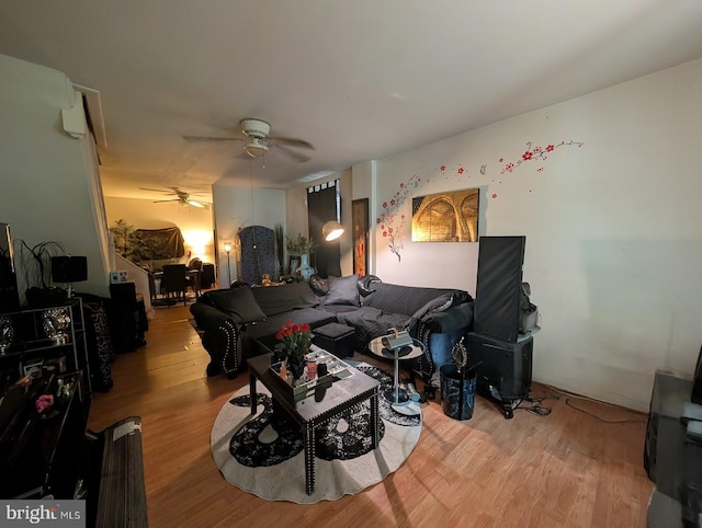 living room featuring a ceiling fan and wood finished floors