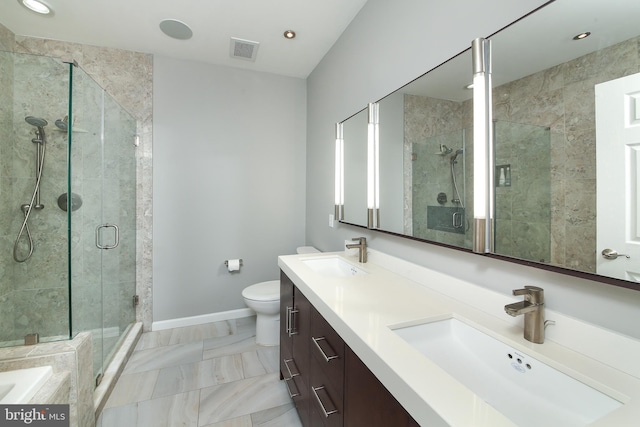 full bath featuring a stall shower, toilet, recessed lighting, baseboards, and double vanity