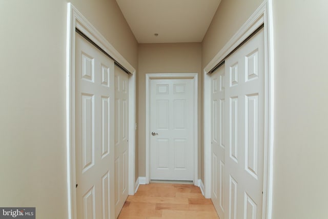 corridor featuring light wood finished floors
