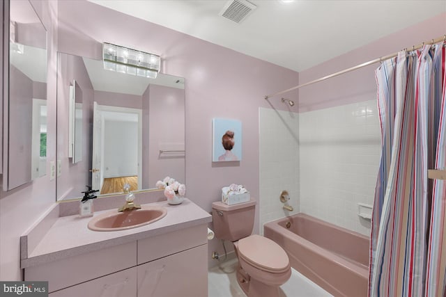 bathroom featuring shower / tub combo with curtain, toilet, and vanity