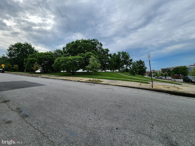 view of street with traffic signs, sidewalks, and curbs