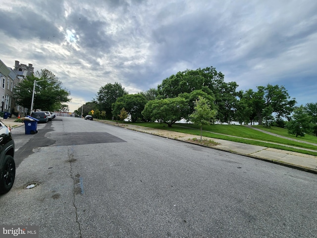 view of road with street lighting, curbs, and sidewalks