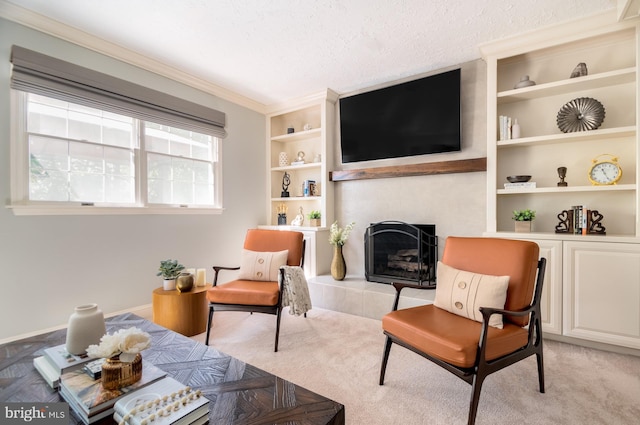 living area featuring a tiled fireplace, a textured ceiling, light carpet, built in shelves, and ornamental molding
