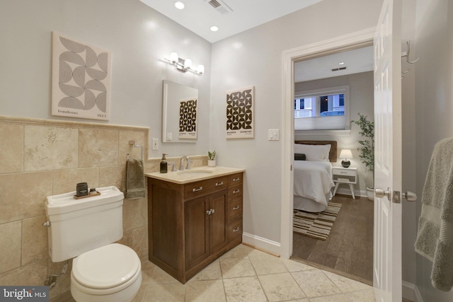 1332 Park Rd NW Unit A, Washington, DC 20010 - bathroom featuring tile walls, toilet, vanity, and ensuite bath