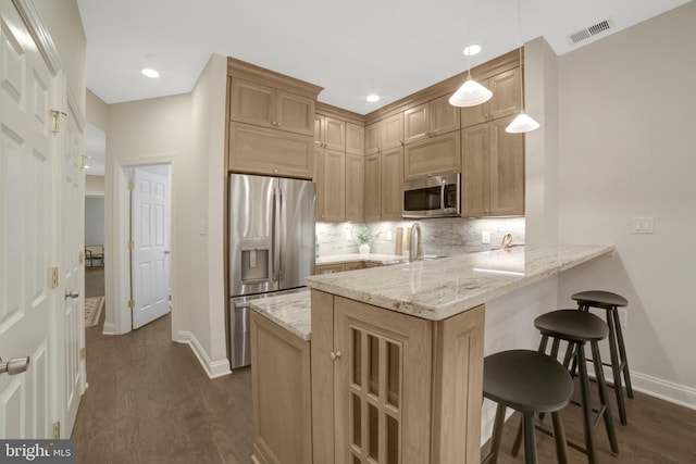 1332 Park Rd NW Unit A, Washington, DC 20010 - kitchen with appliances with stainless steel finishes, a peninsula, dark wood-style floors, baseboards, and a kitchen bar
