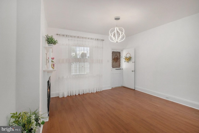 4558 Unruh Ave, Philadelphia, PA 19135 - unfurnished dining area featuring a chandelier, wood finished floors, baseboards, and a fireplace