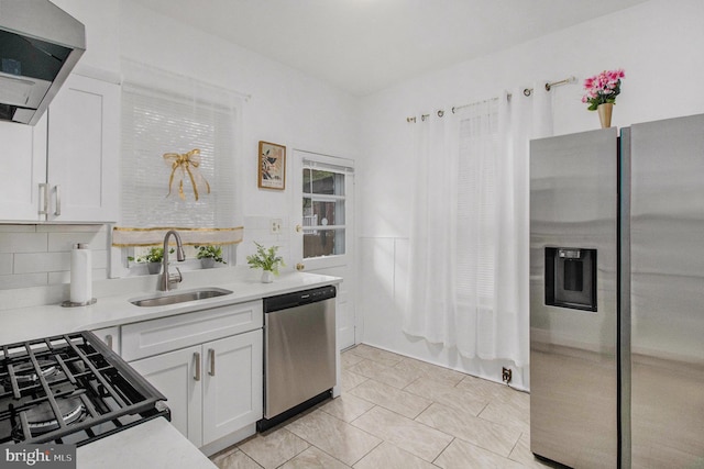 4558 Unruh Ave, Philadelphia, PA 19135 - kitchen with stainless steel appliances, a sink, exhaust hood, and light countertops