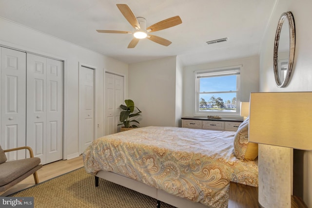 38072 Mockingbird Ln Unit 59, Selbyville, DE 19975 - bedroom with wood finished floors, two closets, and a ceiling fan