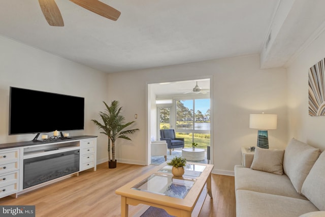 38072 Mockingbird Ln Unit 59, Selbyville, DE 19975 - living room featuring ceiling fan, light wood finished floors, baseboards, and a water view