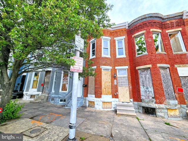 view of front of house featuring brick siding and entry steps