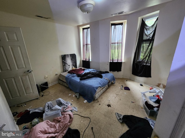 bedroom featuring baseboards and visible vents