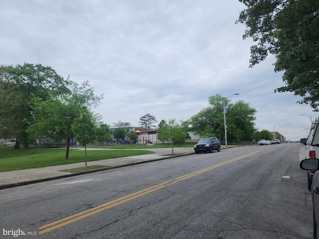view of road with street lighting, curbs, and sidewalks