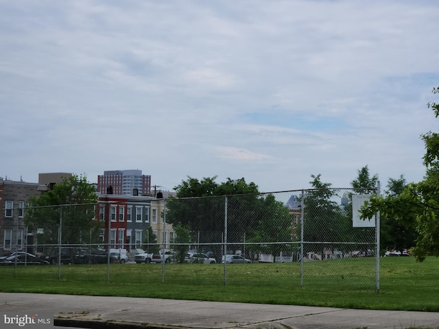 view of community featuring fence and a lawn