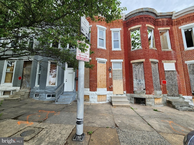 view of front facade featuring entry steps and brick siding