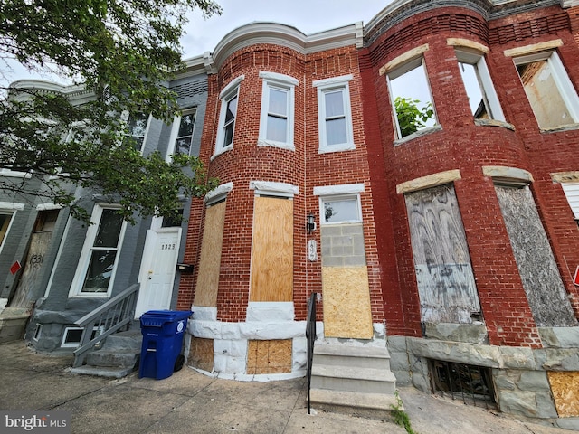 view of front facade with entry steps and brick siding