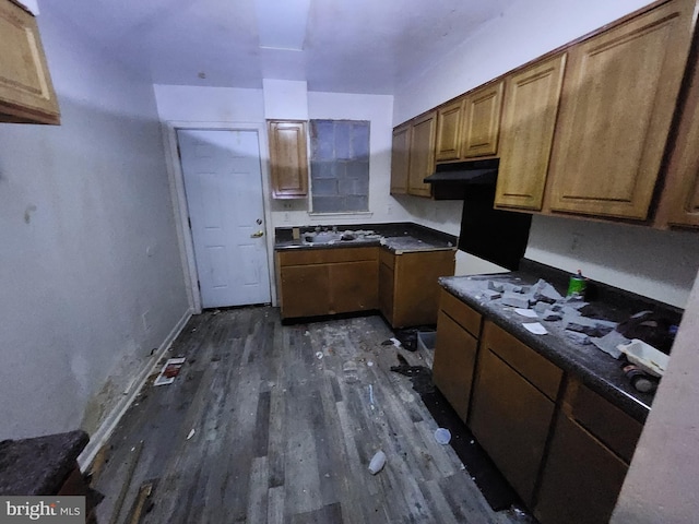 kitchen with brown cabinets, dark countertops, and dark wood-style floors