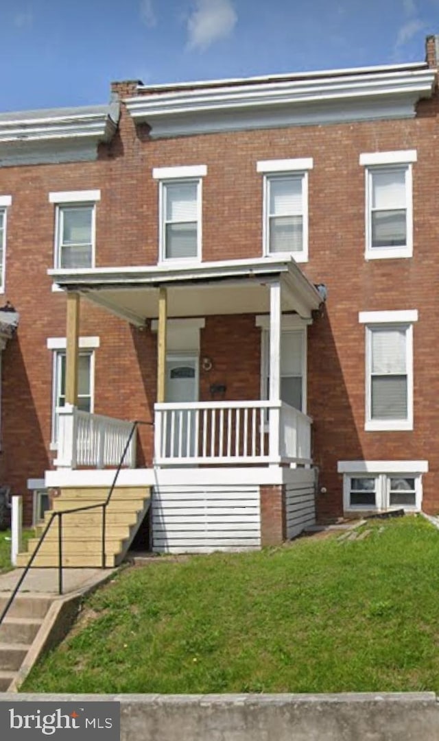 232 Monastery Ave, Baltimore, MD 21229 - multi unit property featuring covered porch, brick siding, a front lawn, and stairway