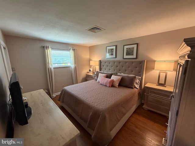bedroom featuring dark wood-type flooring and visible vents