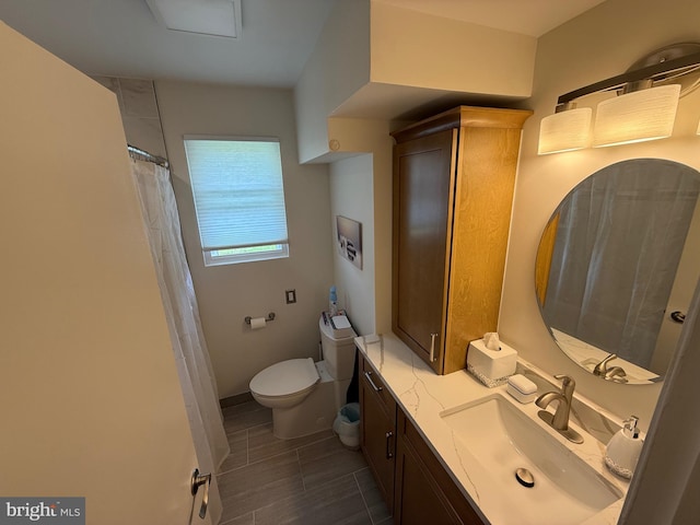 bathroom with toilet and vanity
