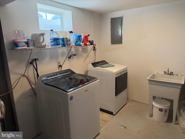 washroom featuring laundry area, washing machine and dryer, and electric panel