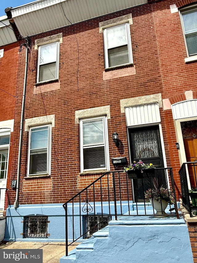 property entrance featuring brick siding