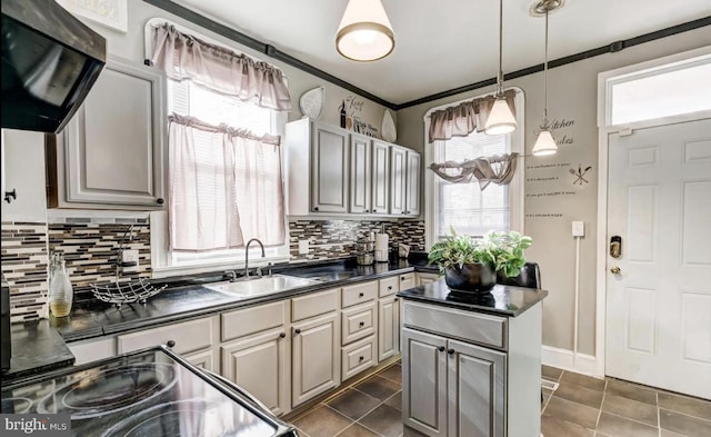 3824 Fairview Ave, Baltimore, MD 21216 - kitchen with dark countertops, a sink, decorative backsplash, range hood, and ornamental molding