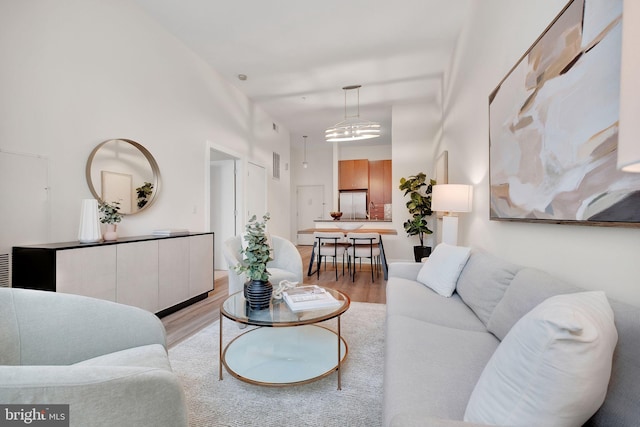 living room featuring light wood-style floors and visible vents