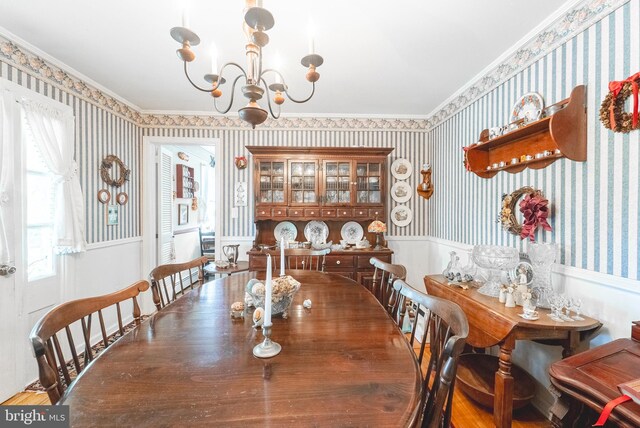 71 Harlingen Rd, Belle Mead, NJ 08502 - dining area featuring ornamental molding, an inviting chandelier, wallpapered walls, and a wainscoted wall