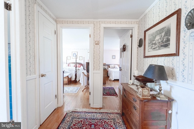 71 Harlingen Rd, Belle Mead, NJ 08502 - hallway featuring crown molding, light wood-style flooring, wallpapered walls, and wainscoting