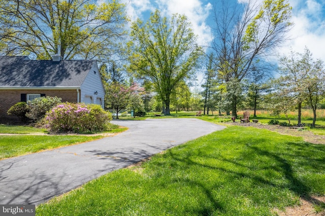 71 Harlingen Rd, Belle Mead, NJ 08502 - view of community featuring a yard, aphalt driveway, and a garage