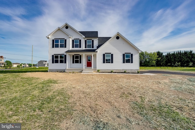 view of front of property featuring a front yard and roof with shingles