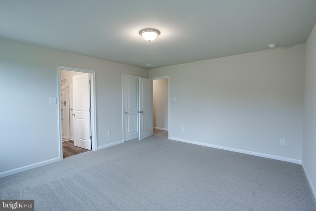 unfurnished bedroom featuring baseboards and carpet flooring