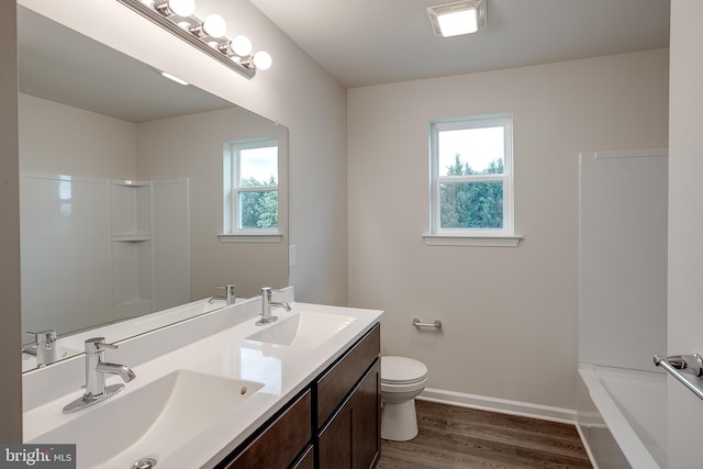 full bathroom featuring a sink, toilet, plenty of natural light, and wood finished floors