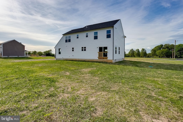 rear view of house featuring a lawn