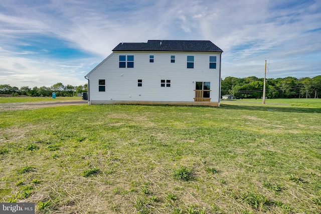 back of property with a yard